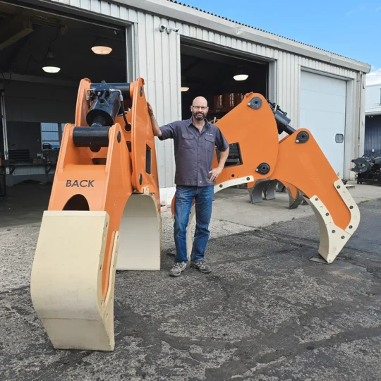 LaValley Industries CEO, Jason LaValley, stands next to a set of 56-Inch Pipe Arms