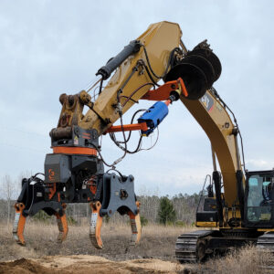 Utility Auger is seen attached to the stick of an excavator along with a DECKHAND®5HP with Utility Arms